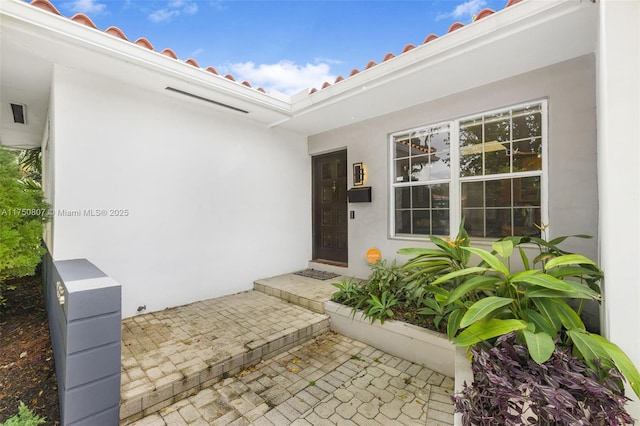 doorway to property with stucco siding