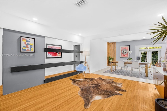 interior space with recessed lighting, light wood-style flooring, visible vents, and french doors