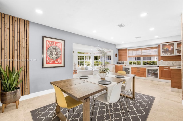 dining room with wine cooler, baseboards, and recessed lighting