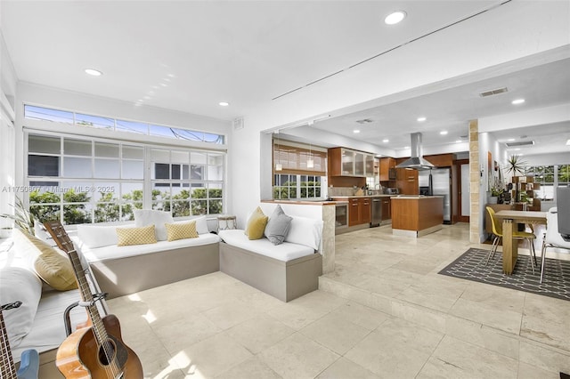 living room featuring a healthy amount of sunlight, visible vents, and recessed lighting