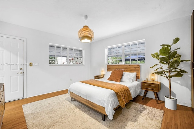 bedroom with light wood-style floors and baseboards