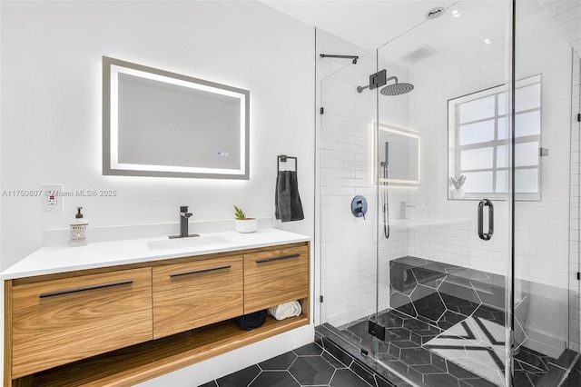 full bathroom featuring a shower stall, vanity, and tile patterned floors