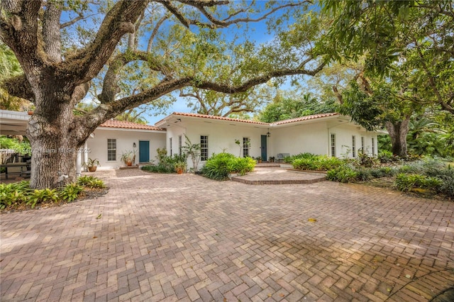 mediterranean / spanish-style house with a tiled roof and stucco siding