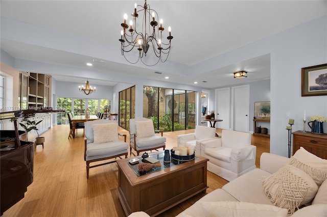 living area with light wood-type flooring, a chandelier, and recessed lighting