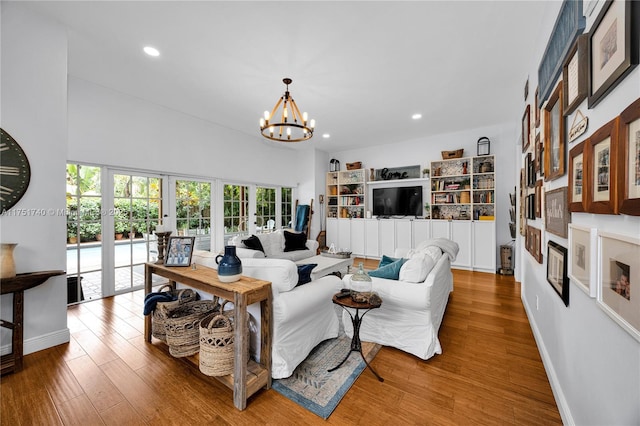 living room with an inviting chandelier, wood finished floors, and recessed lighting