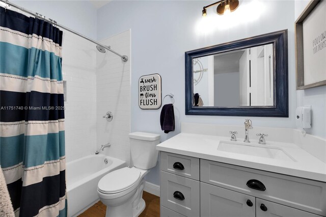 full bathroom with shower / tub combo with curtain, vanity, toilet, and wood finished floors