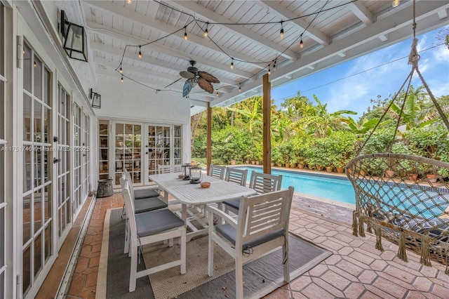 exterior space featuring french doors, beamed ceiling, track lighting, and ceiling fan