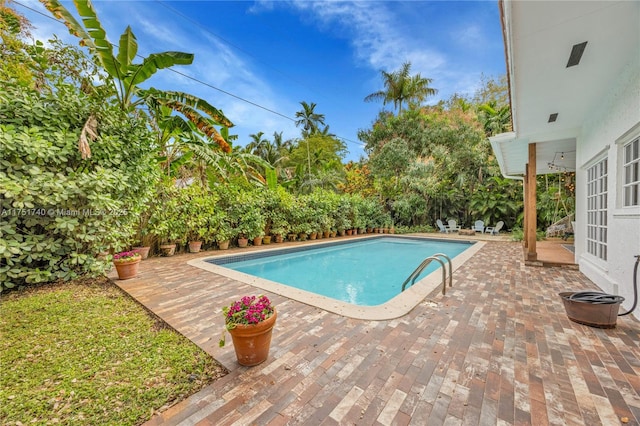 outdoor pool with french doors and a patio area