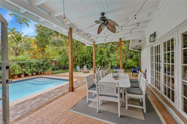 view of patio featuring ceiling fan, outdoor dining area, a fenced backyard, french doors, and a fenced in pool