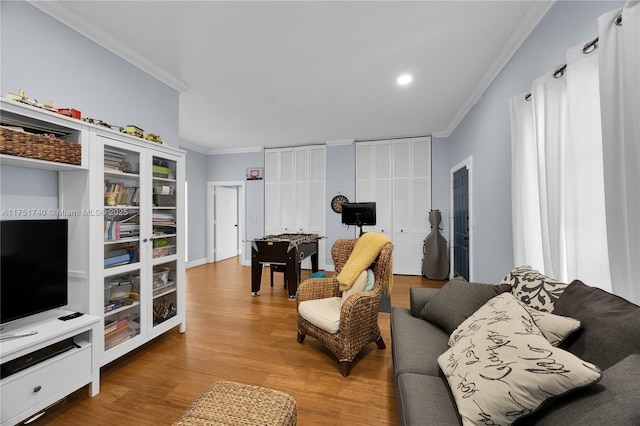 living room featuring crown molding and wood finished floors