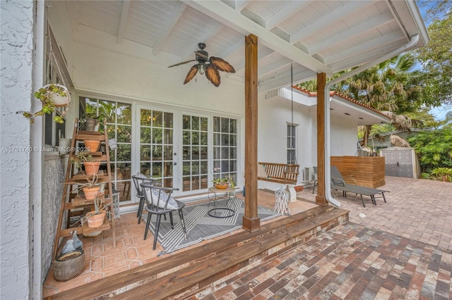 wooden deck featuring a ceiling fan and french doors