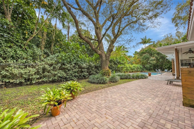 view of patio / terrace with an outdoor pool and ceiling fan