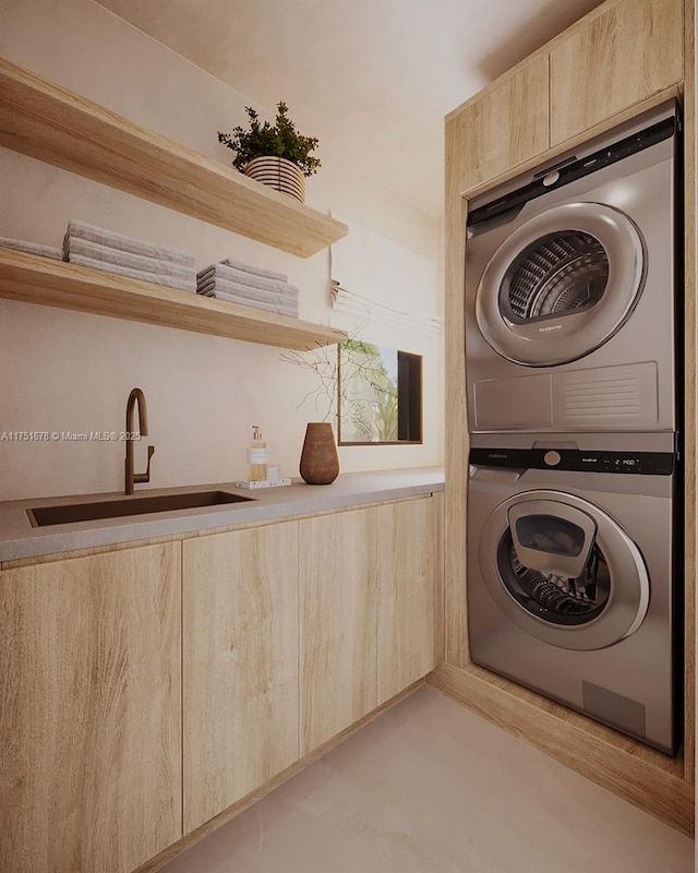 laundry room with stacked washing maching and dryer and a sink