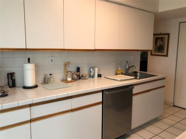 kitchen with white cabinets, decorative backsplash, stainless steel dishwasher, and a sink