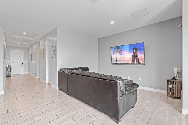 living area featuring wood tiled floor, baseboards, and recessed lighting