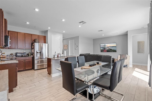 dining space featuring a toaster, recessed lighting, visible vents, baseboards, and light wood finished floors