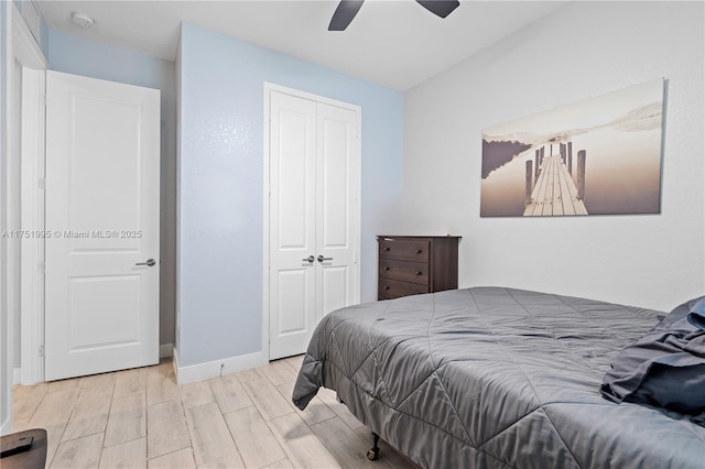 bedroom featuring ceiling fan, baseboards, a closet, and wood finish floors