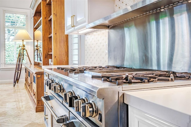 16721 SW 86th Ct, Palmetto Bay, FL 33157 - kitchen featuring high end range, tasteful backsplash, white cabinets, wall chimney exhaust hood, and baseboards