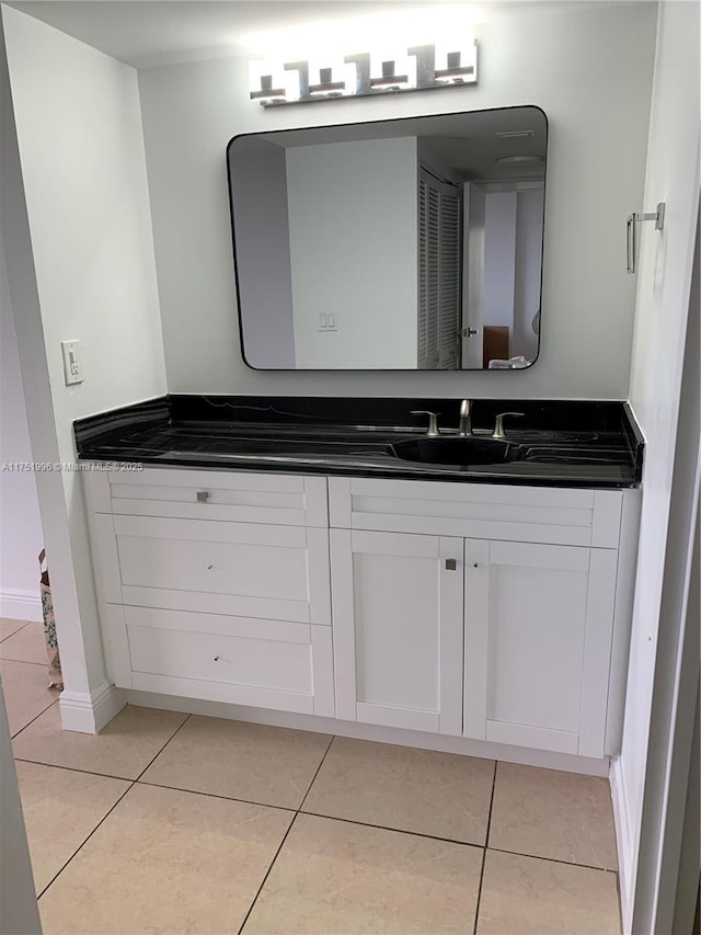 bathroom with tile patterned flooring, vanity, and baseboards