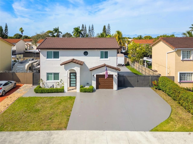 mediterranean / spanish-style home featuring a tile roof, driveway, a residential view, stucco siding, and a front lawn