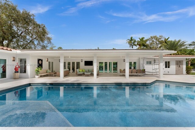6784 SW 97th St, Pinecrest, FL 33156 - swimming pool featuring french doors, outdoor lounge area, and a patio area