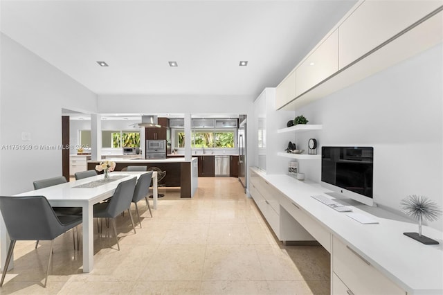 6784 SW 97th St, Pinecrest, FL 33156 - kitchen with modern cabinets, appliances with stainless steel finishes, light countertops, a kitchen island, and white cabinetry