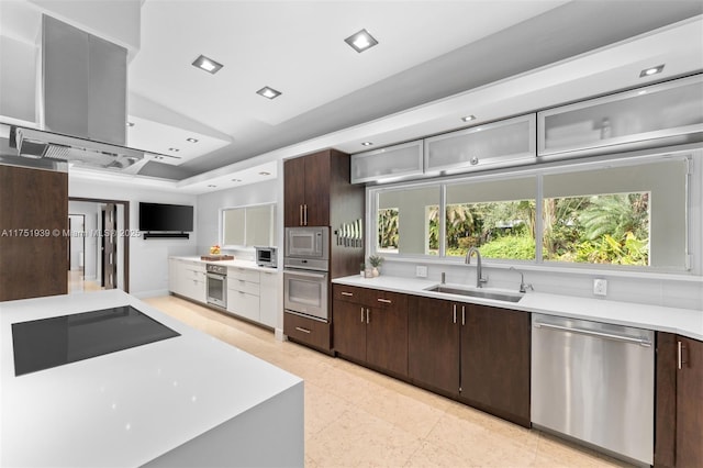 6784 SW 97th St, Pinecrest, FL 33156 - kitchen with stainless steel appliances, a sink, light countertops, dark brown cabinetry, and recessed lighting