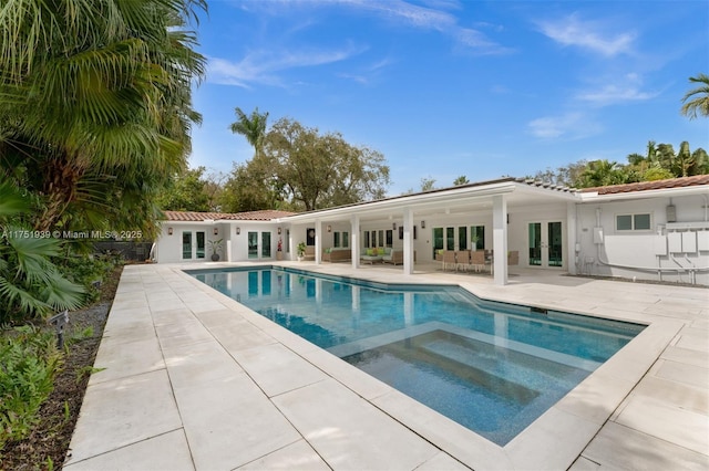 6784 SW 97th St, Pinecrest, FL 33156 - swimming pool featuring french doors, an in-ground hot tub, and a patio area