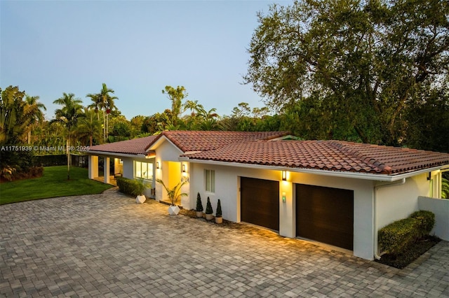 6784 SW 97th St, Pinecrest, FL 33156 - mediterranean / spanish-style home with stucco siding, a garage, a front yard, and a tile roof