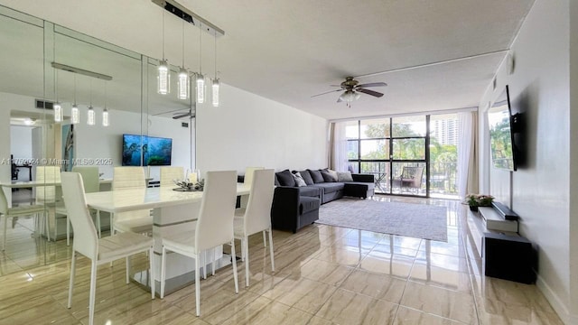 dining space featuring expansive windows, visible vents, and ceiling fan