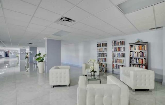 sitting room featuring a paneled ceiling and visible vents