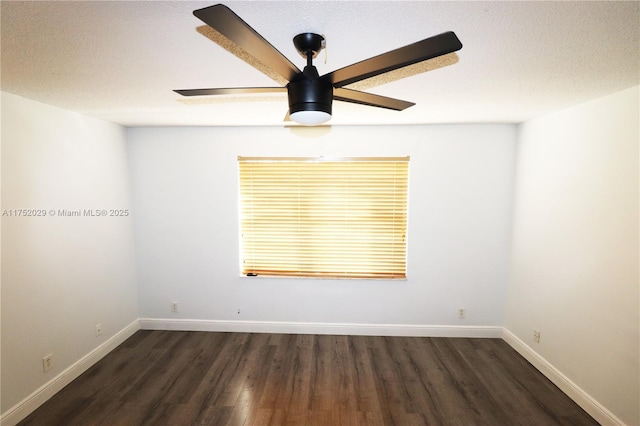 empty room with ceiling fan, a textured ceiling, baseboards, and wood finished floors