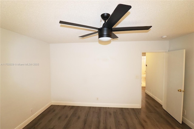 empty room featuring a ceiling fan, a textured ceiling, baseboards, and dark wood-type flooring