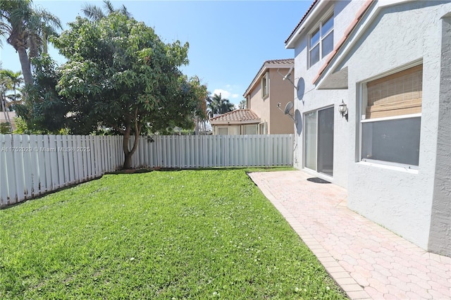 view of yard with a fenced backyard and a patio