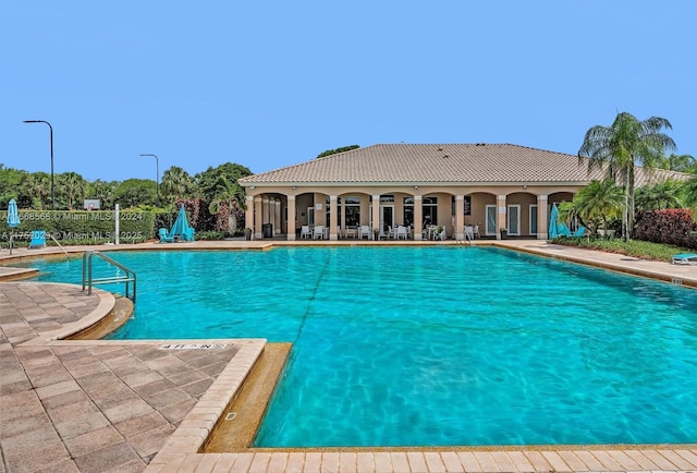 pool with fence and a patio