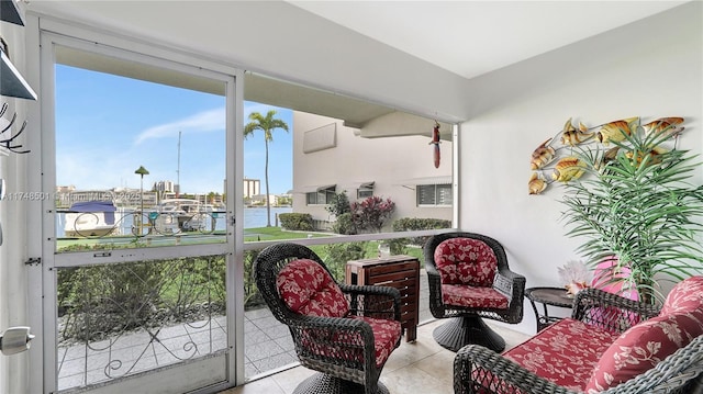 sunroom / solarium featuring a water view