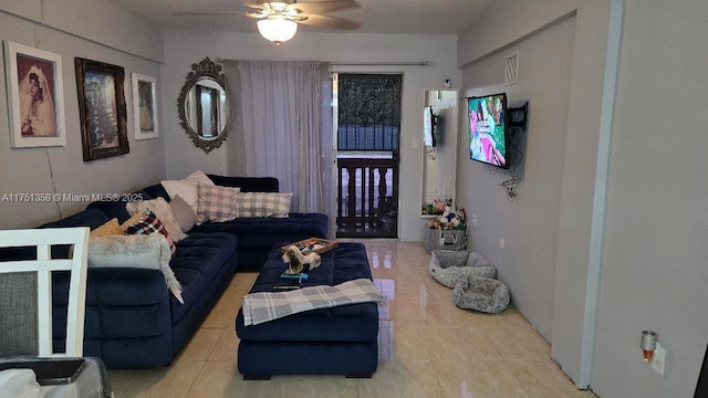 living room with a ceiling fan and tile patterned flooring