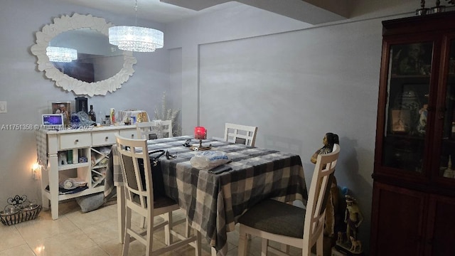 dining space featuring light tile patterned flooring and a notable chandelier