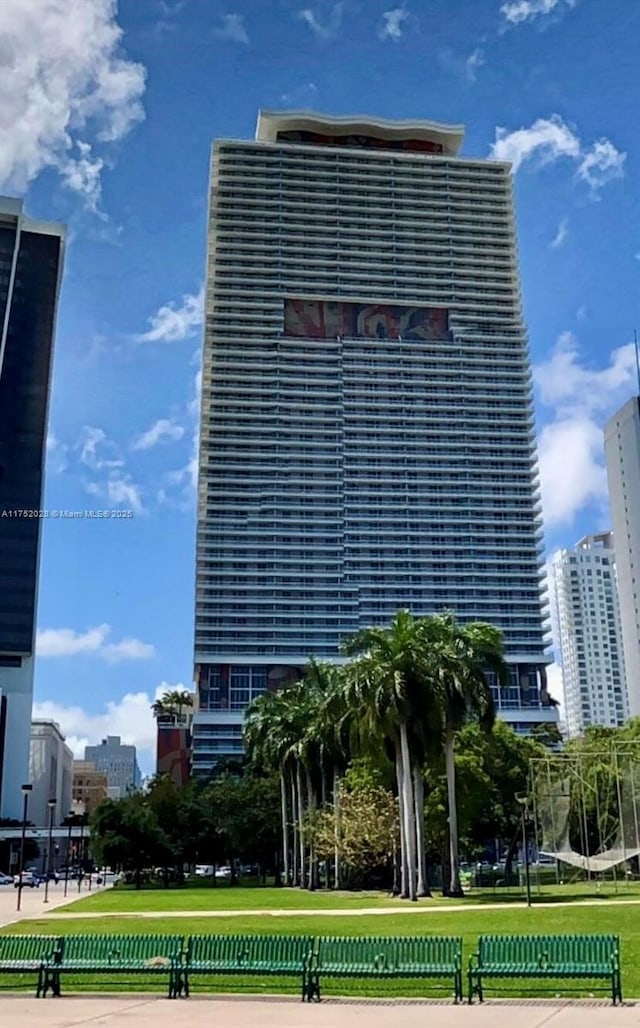 view of building exterior featuring a view of city and fence