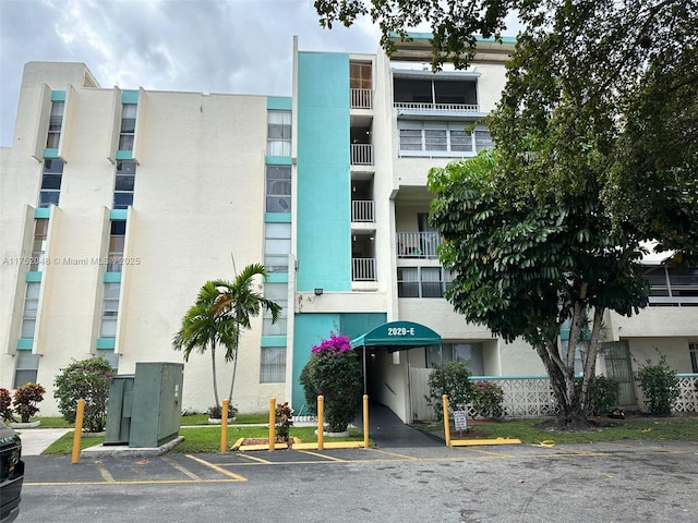 view of property featuring uncovered parking