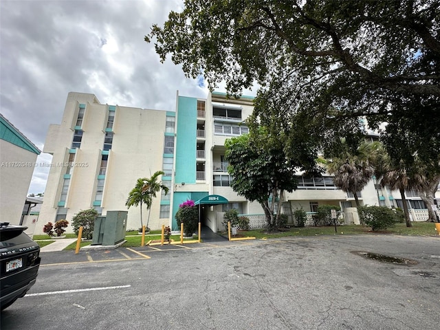 view of property featuring uncovered parking