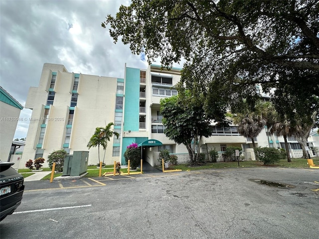 view of building exterior featuring uncovered parking