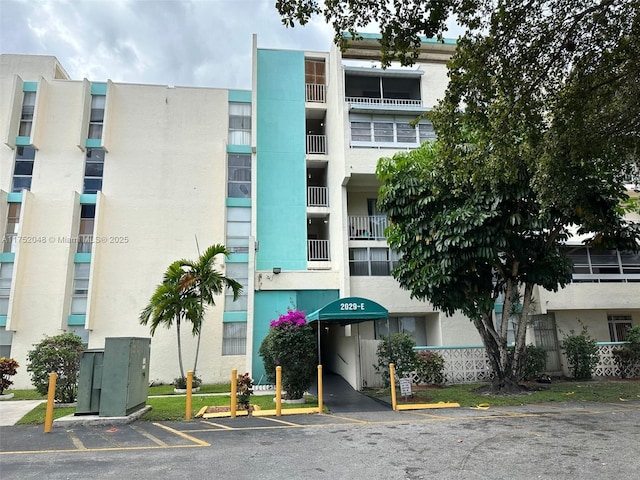 view of property featuring uncovered parking