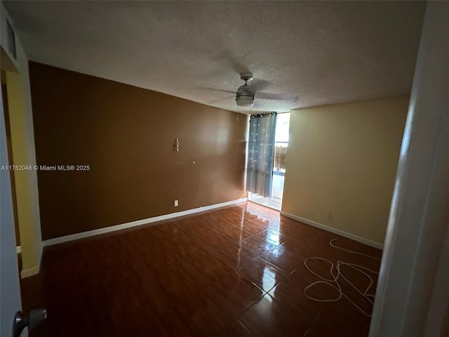 unfurnished room featuring a ceiling fan, a textured ceiling, and baseboards