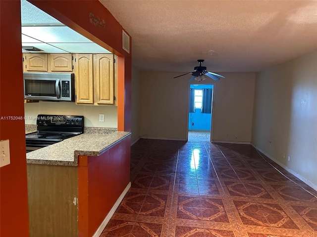 kitchen featuring black electric range, light countertops, visible vents, stainless steel microwave, and a textured ceiling