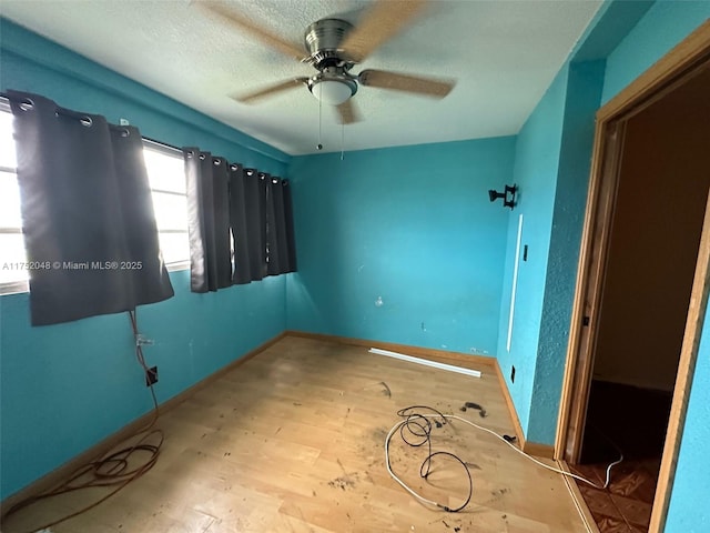 unfurnished bedroom with baseboards, ceiling fan, a textured ceiling, and light wood finished floors