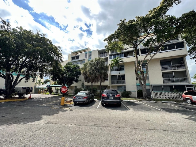 view of building exterior featuring uncovered parking