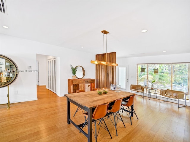 dining space with light wood-type flooring, visible vents, and recessed lighting