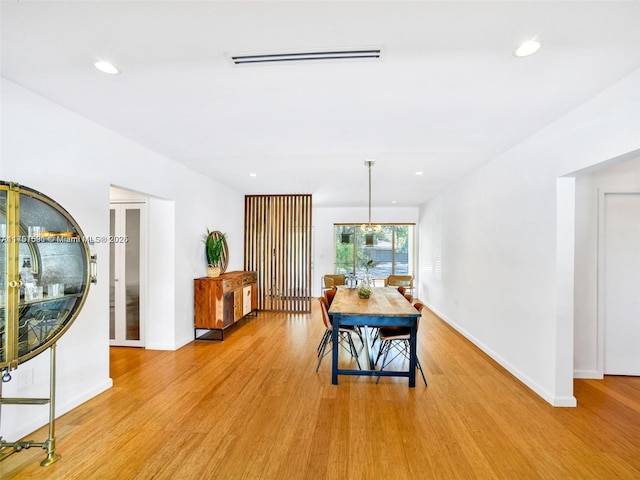 dining space with baseboards, recessed lighting, visible vents, and light wood-style floors