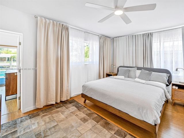 bedroom with a ceiling fan and light wood-style floors